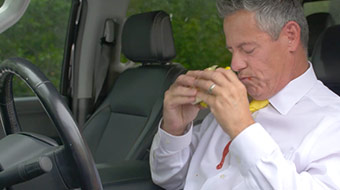 Guy spilling food in car