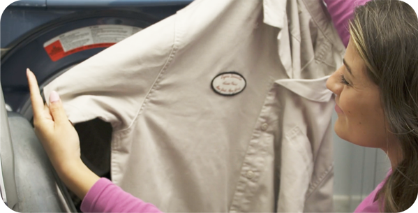 Woman looking at removed stains from shirt
