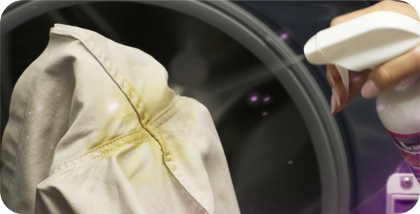 Spraying Dream Stain Remover on stained clothes